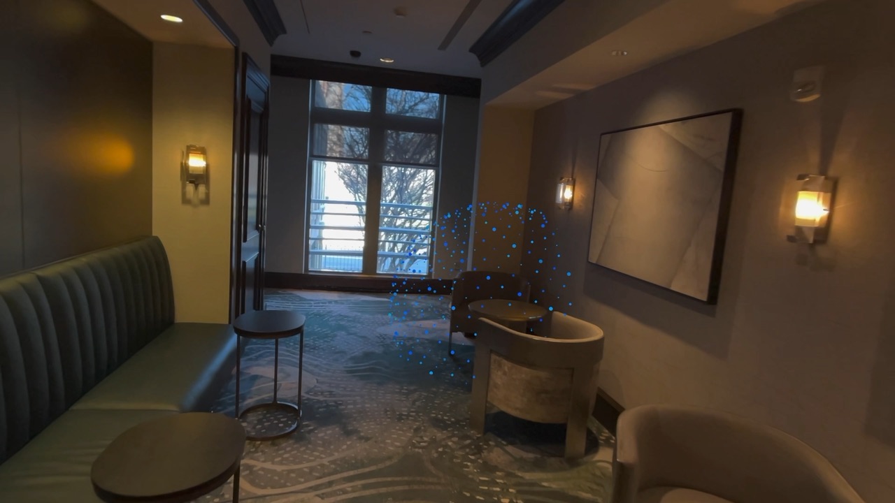 A faint sphere of blue dots at the end of a hallway